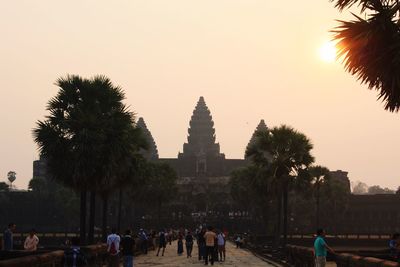 People at temple against clear sky