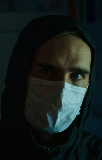 Close-up portrait of young man covering face