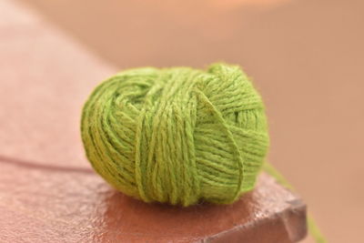 Close-up of green leaf with ball on table