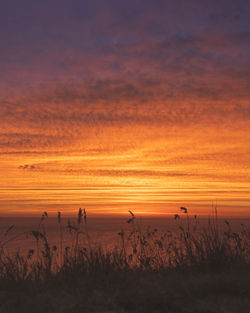 Scenic view of silhouette land against sky during sunset