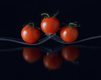 Close-up of cherry tomatoes against black background