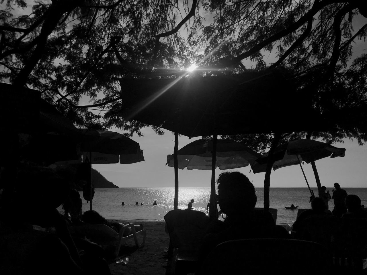 SILHOUETTE PEOPLE ON BEACH AGAINST SKY DURING SUNRISE