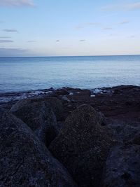 Scenic view of sea against sky at sunset