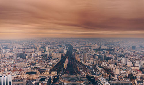 High angle view of cityscape against cloudy sky