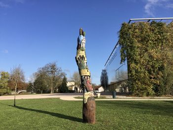 Statue on field against clear sky