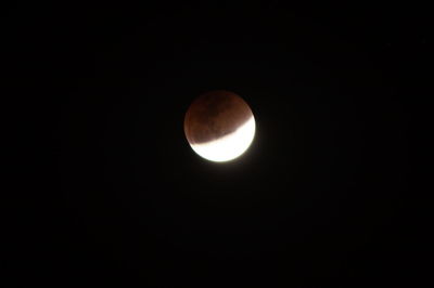 Low angle view of moon against clear sky at night