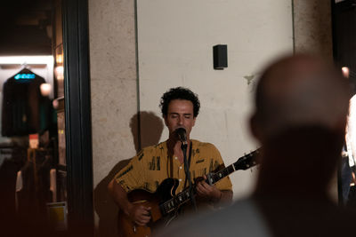 Portrait of young man playing guitar