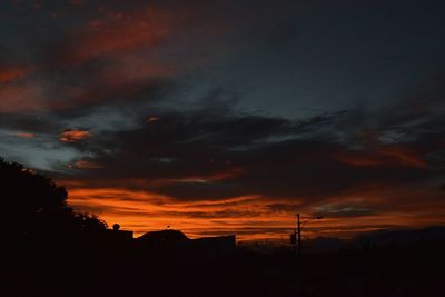 Silhouette trees against sky during sunset