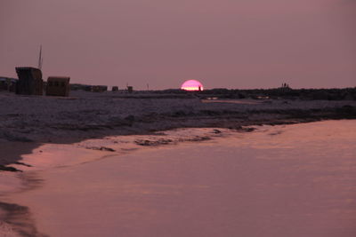 Scenic view of beach against sky during sunset