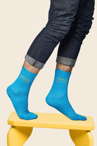 Low section of person standing against blue background