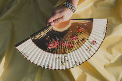 Cropped image of man holding dartboard
