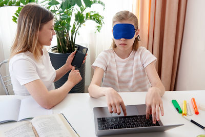 Mother helping daughter with homework