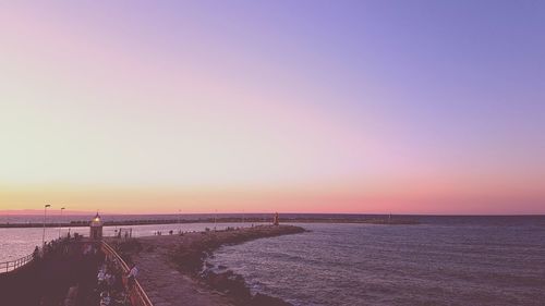 Scenic view of sea against clear sky during sunset