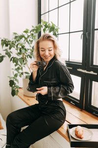 Young woman sitting on table