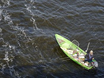 High angle view of man sitting in sea