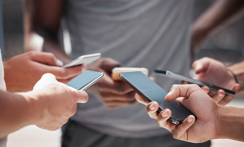 Midsection of man using mobile phone