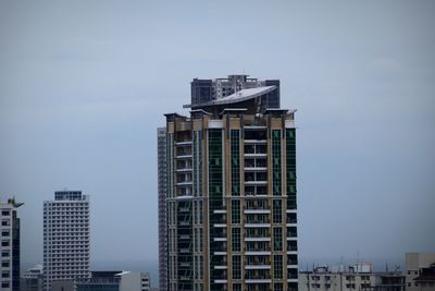 Low angle view of modern buildings against sky in city