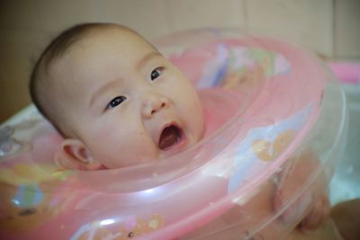 Close-up portrait of cute baby with inflatable ring