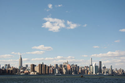 View of city skyline against cloudy sky