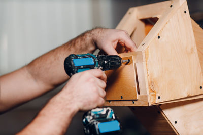 Cropped hand of man holding equipment