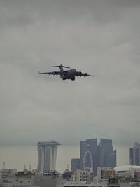 Low angle view of airplane flying against sky