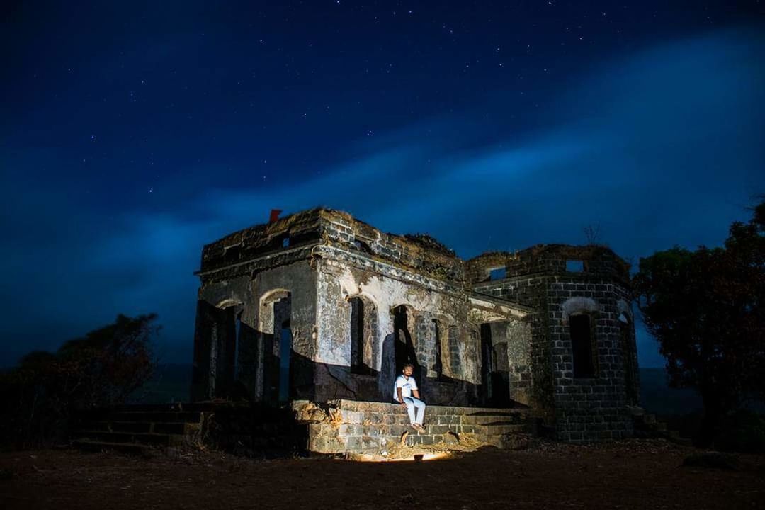 LOW ANGLE VIEW OF BUILT STRUCTURE AT NIGHT