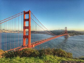 Golden gate bridge over bay of water against sky