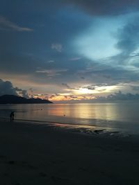 Scenic view of beach against sky during sunset