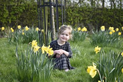 Portrait of happy girl with sunflowers in background