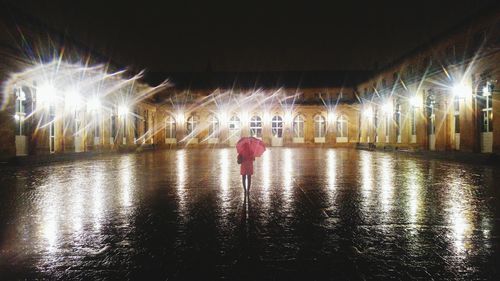 Man in illuminated water at night