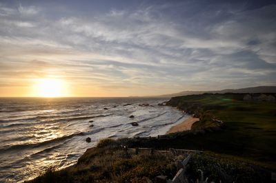 Scenic view of beach against sky during sunset