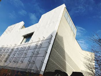 Low angle view of building against cloudy sky