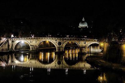 View of bridge over river at night