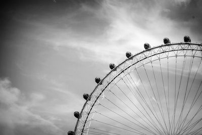 Low angle view of ferris wheel against clear blue sky