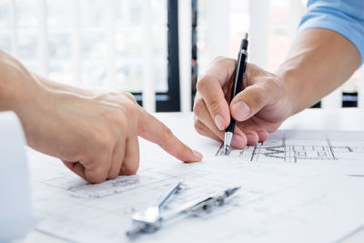 Midsection of man working on table