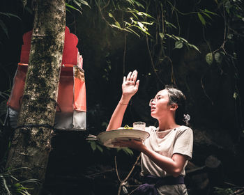Side view of woman sitting outdoors