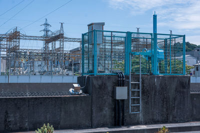 Construction site in city against sky