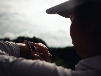 Close-up of woman checking time outdoors