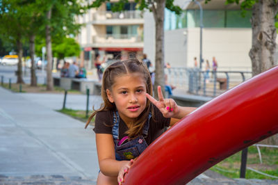 Portrait of girl showing peace sign