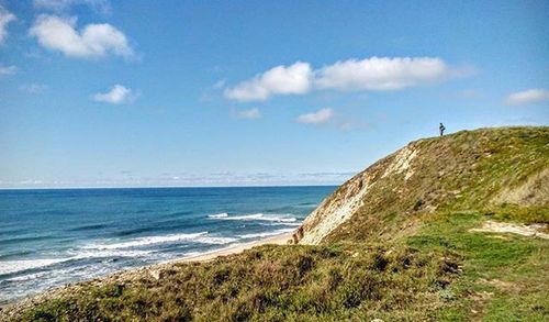 Scenic view of sea against cloudy sky