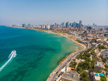 High angle view of sea and buildings against sky