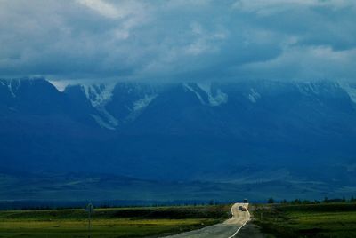 Countryside road leading towards mountains