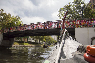 Bridge over river in city against sky