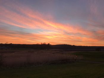 Scenic view of field against sky during sunset