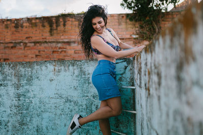 Beautiful woman standing at abandoned swimming pool