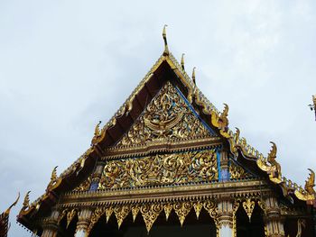 Low angle view of temple roof against sky