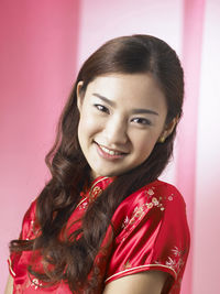 Portrait of smiling woman against backdrop