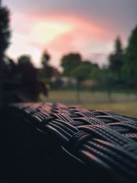 Close-up of guitar against sky during sunset