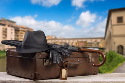 Close-up of suitcase on table against sky