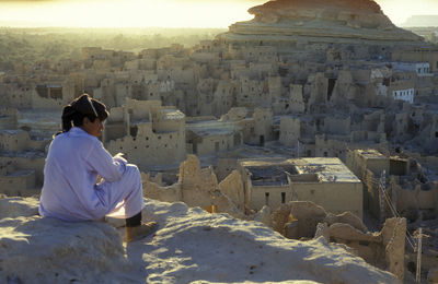Rear view of woman looking at cityscape